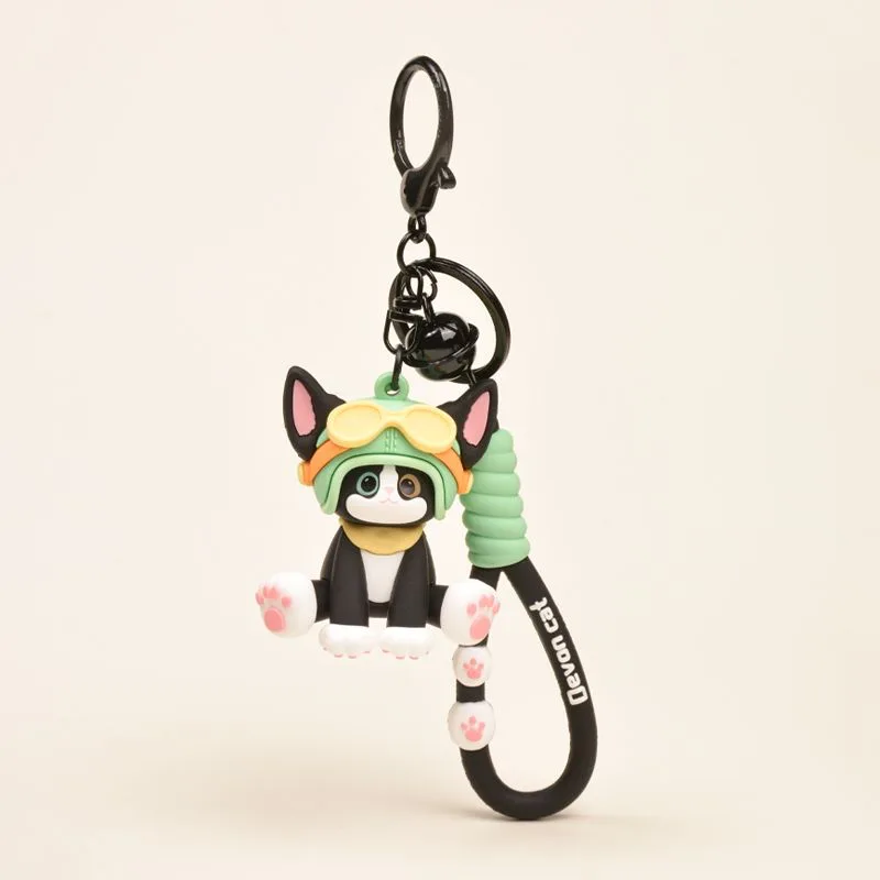 Devon Cat keychain featuring black and white cat figurine wearing aviator goggles and helmet with bell