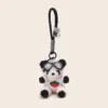 Plush panda keychain wearing goggles and strawberry sweater with black loop strap