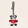 Plush panda keychain wearing red sweater with heart and aviator goggles on black strap