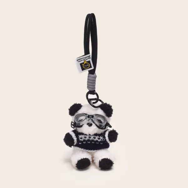 Plush panda keychain wearing aviator goggles and knit sweater with black strap