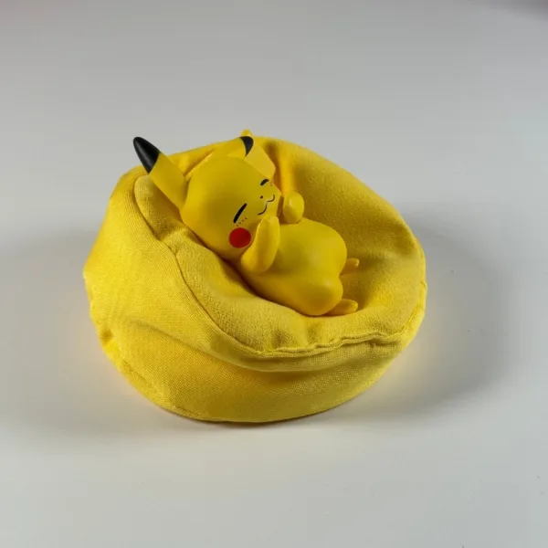 Pokémon Pikachu Ornament (2) Sleeping Pikachu figurine resting in a yellow bean bag cushion