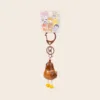 Brown chicken-shaped keychain with yellow feet and cute animal character packaging card