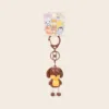 Cute brown dog character keychain with yellow face on retail card featuring cartoon animals