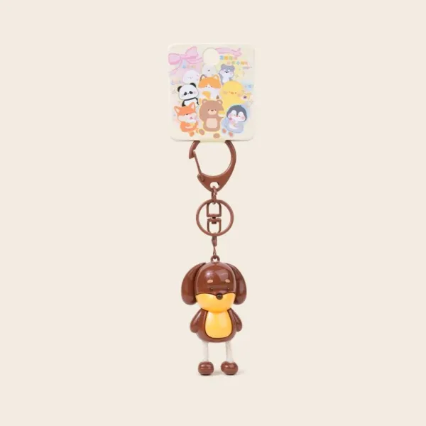 Cute brown dog character keychain with yellow face on retail card featuring cartoon animals