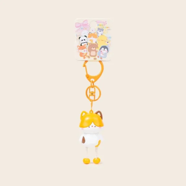 Cute cat keychain with yellow fox hood, white body, and orange clasp on retail card