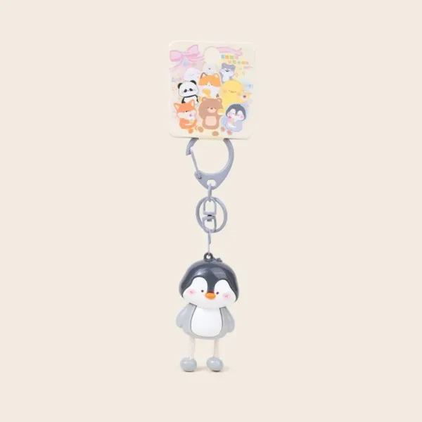 Cute penguin keychain with gray clasp and dangling rope legs on colorful animal character backing card