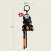 Toothless dragon keychain figurine holding orange fish, 4.5cm x 4cm with braided strap