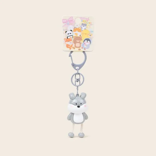 Cute gray wolf keychain charm with dangling legs on colorful animal-themed retail card