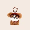Plush brown teddy bear keychain wearing Lucky cap, round glasses, and checkered bandana