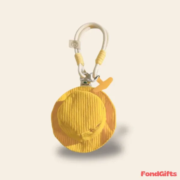 Yellow corduroy bucket hat keychain with white carabiner clip and CRYLER branding, decorative bag accessory