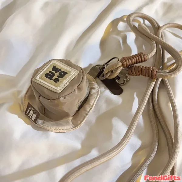 Beige mini bucket hat pouch with wgac patch and PKi label, attached to rope lanyard with metal clips on white fabric