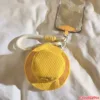 Yellow Corduroy Mini Hat Phone Charm Keychain Accessory Yellow corduroy mini bucket hat coin purse with CRYLER label attached to smartphone case via white lanyard strap