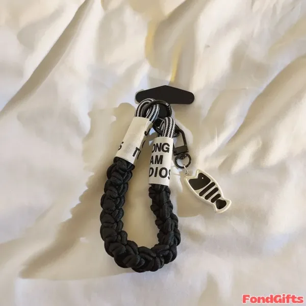 Black braided phone strap with fish bone charm and ONG AM DIOS ribbon tag