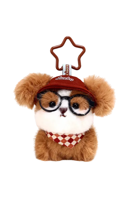 Plush brown teddy bear keychain wearing round glasses, red Lucky cap, and checkered bandana with star-shaped clip attachment
