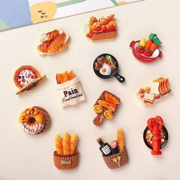 Colorful food-themed refrigerator magnets featuring bread, pizza, pastries, and seafood dishes