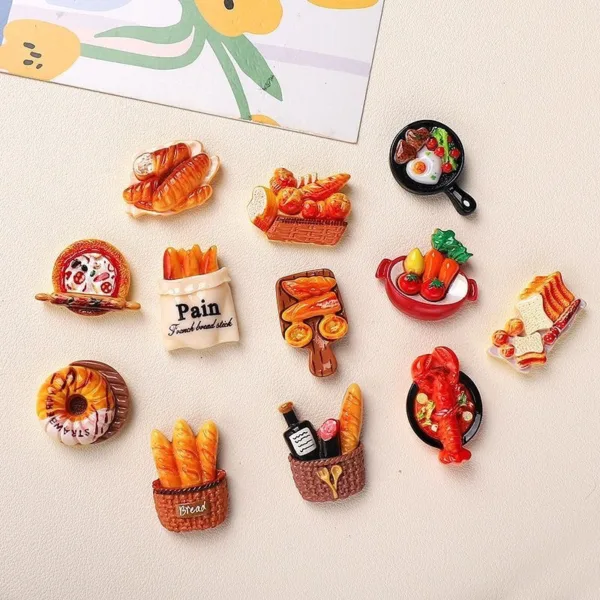 Colorful food-themed refrigerator magnets featuring bread, pastries, lobster, and breakfast items