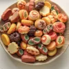 Colorful assortment of traditional petit fours and decorated cookies on a beige plate