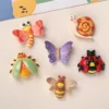 Colorful resin insect charms featuring dragonfly, snail, butterfly, beetle, ladybug, and bee designs