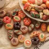 Assorted miniature decorative bread and pastry charms on brown paper and plate