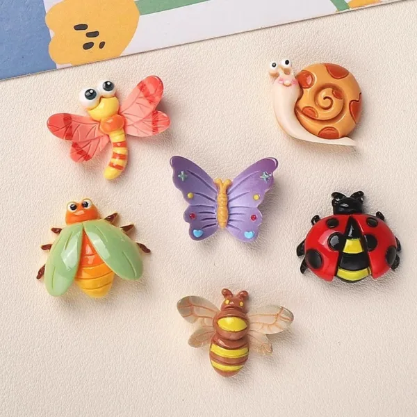 Colorful resin insect charms featuring dragonfly, snail, butterfly, beetle, ladybug, and bee designs