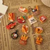 Miniature food magnets featuring bread baskets, pizza, croissants, and cooking pans on newspaper background