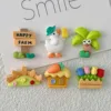 Cute farm-themed resin charms featuring Happy Farm sign, duck, carrot, house, fence, and tulip planter
