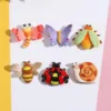 Six colorful resin bug charms featuring dragonfly, butterfly, beetle, bee, ladybug, and snail