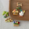 Cute farm-themed resin charms with Happy Farm sign, duck, cottage, tulips, and palm tree on wooden tray