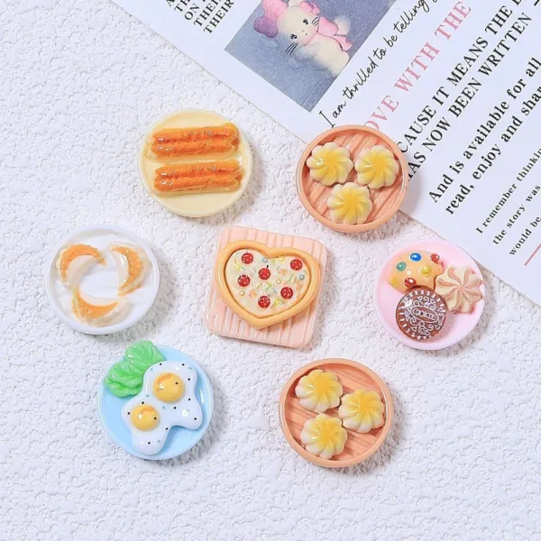 Miniature resin food charms featuring dumplings, fried eggs, pizza, cookies, and churros on tiny plates